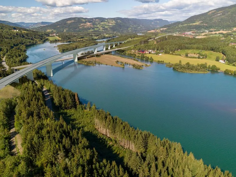 I kommunedelplanen ble det vist fram en høy og lang motorveibru plassert i bue over Våløya og Lågen. Brukonstruksjonen Nye Veier nå arbeider med blir vesentlig mindre omfattende og mindre synlig i terrenget.