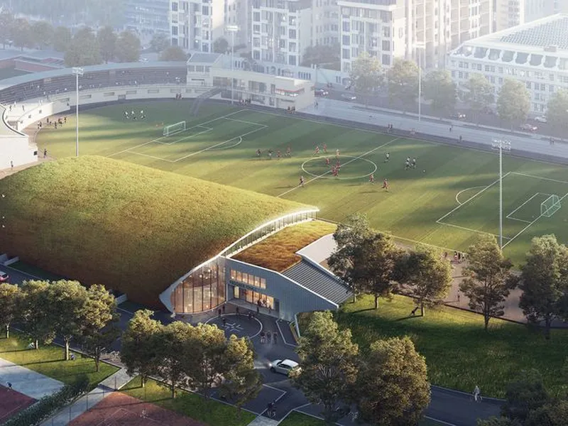 Arkitektene har utformet hallen slik at den vil fremstå godt integrert i omgivelsene og tilpasset det fredede området det skal ligge i. Illustrasjon: Dyrvik Arkitekter AS