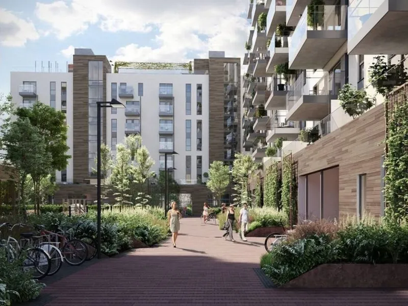 Kvinne går i et gatetun mellom boligblokker i Oslo. Illustrasjon. 