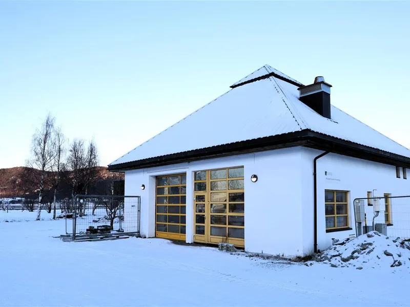 Hvitt murbygg på en snøkledd flate.  - Klikk for stort bilde