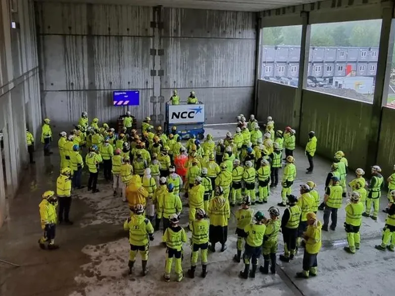 En gruppe mennesker i gule jakker