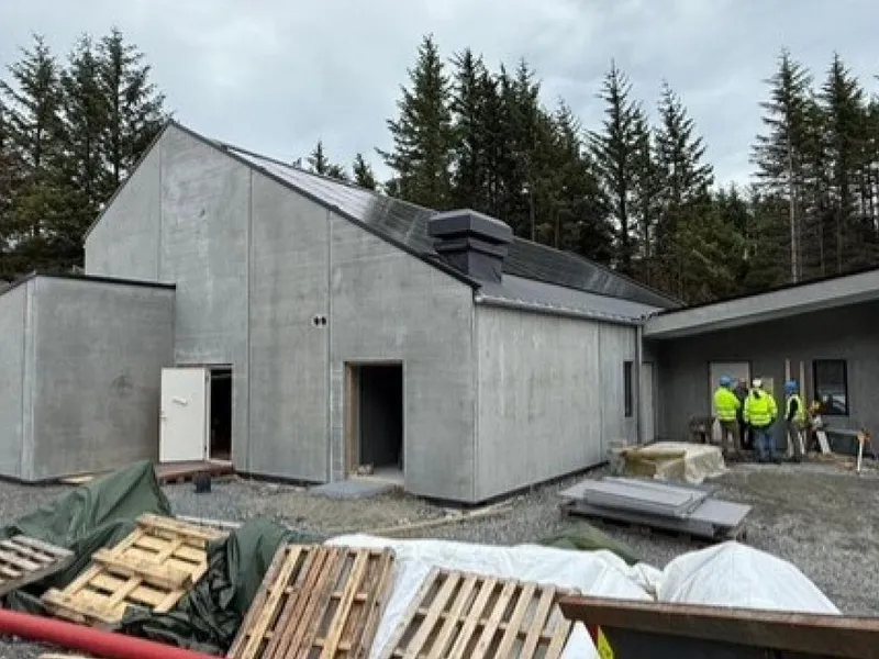 Et murhus som bygges, med materialer og utstyr liggende rundt.